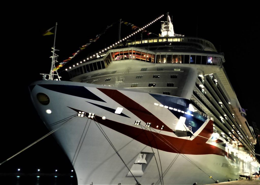 Large cruise liner decorated with festoon lighting for celebrations