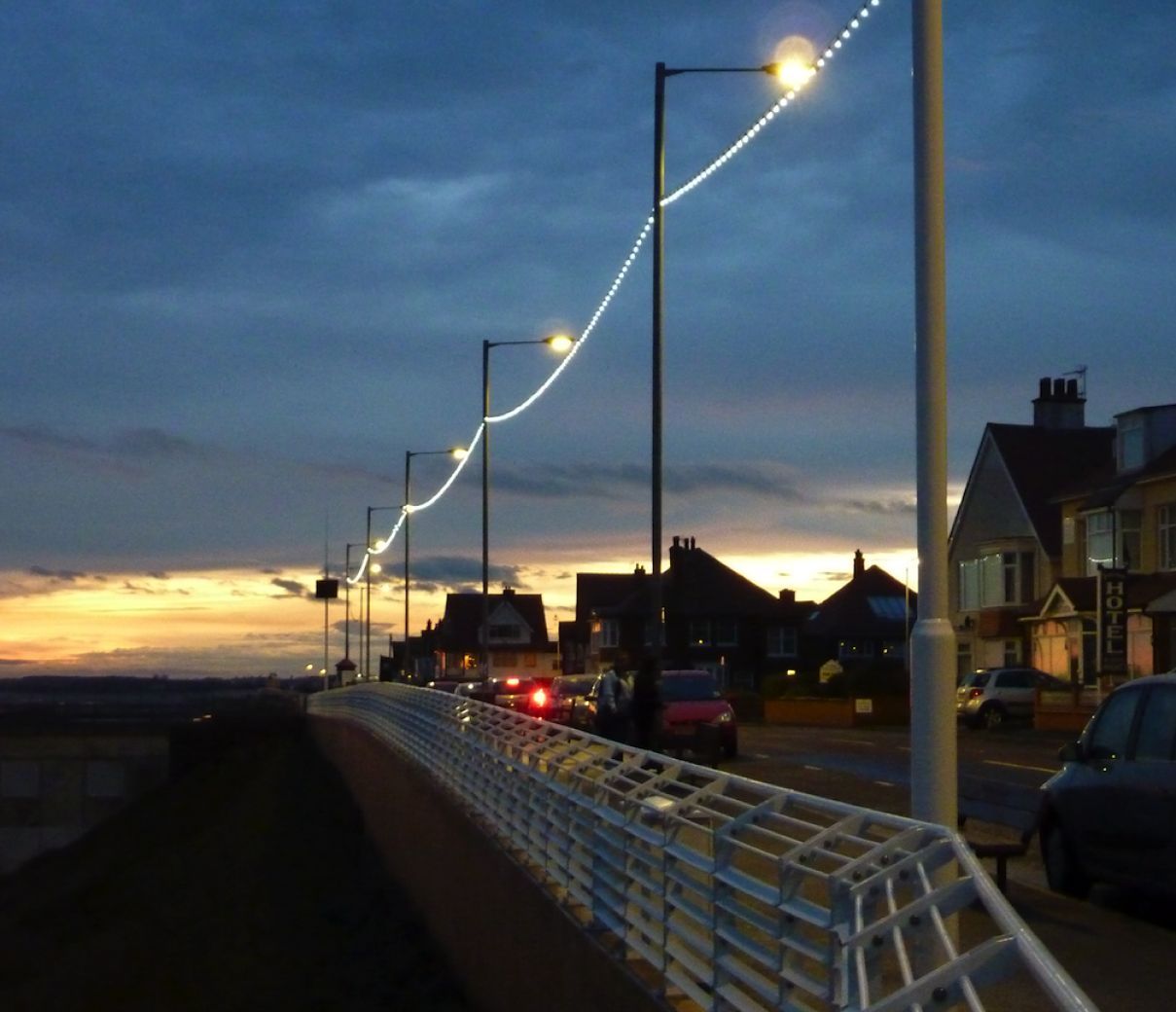 Seafront promenade lit up with festoon lighting